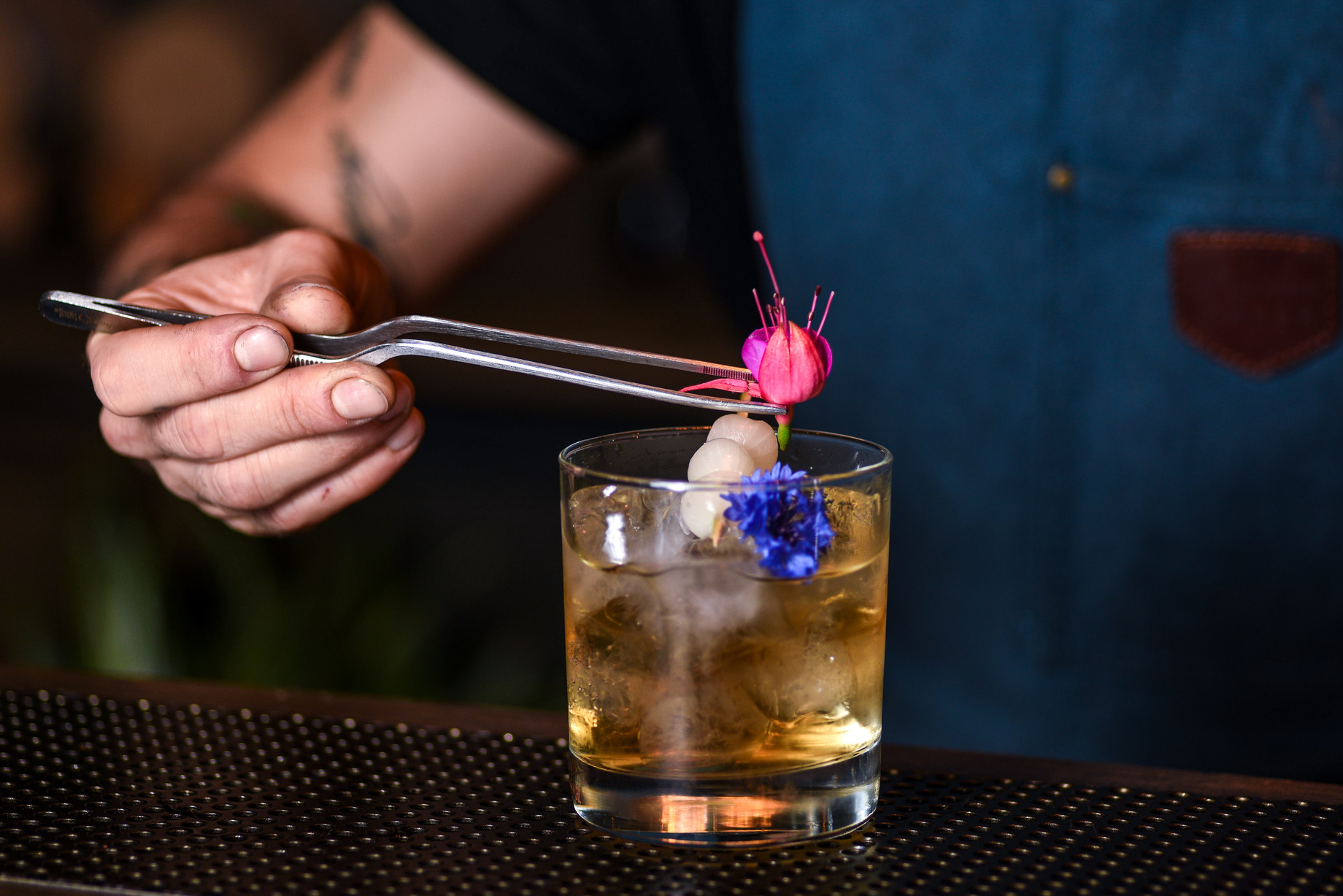 A Bartender Putting Flower on a Cocktail Drink